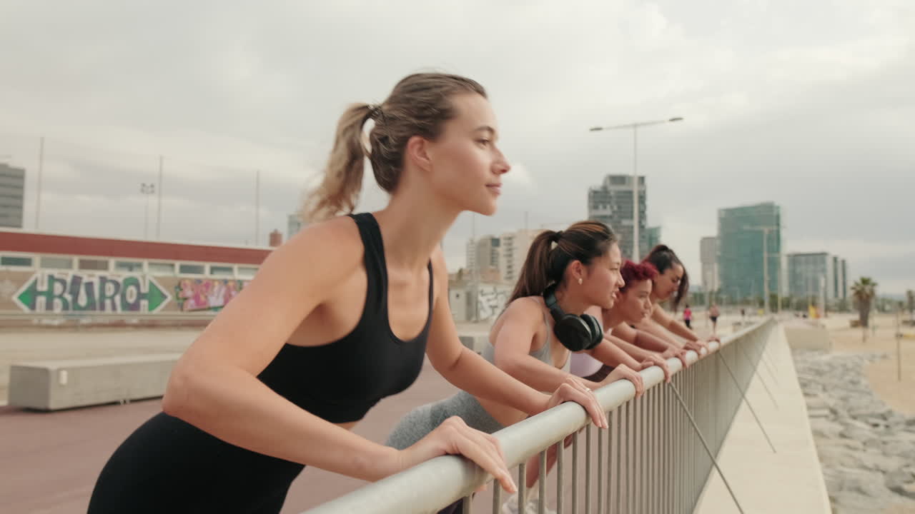 Four Women Doing Incline Pushups Near Beach