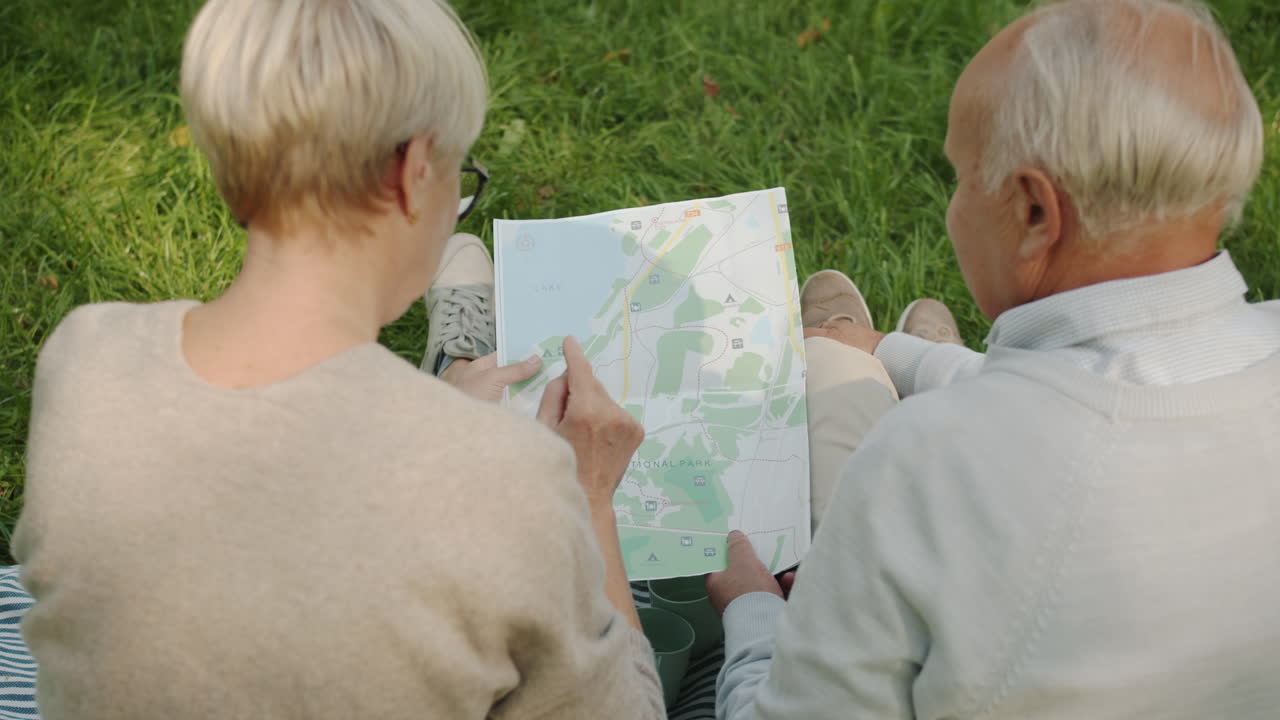 Senior Couple Exploring Park with Map