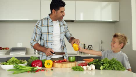 Little-boy-handing-his-father-a-yellow-pepper-