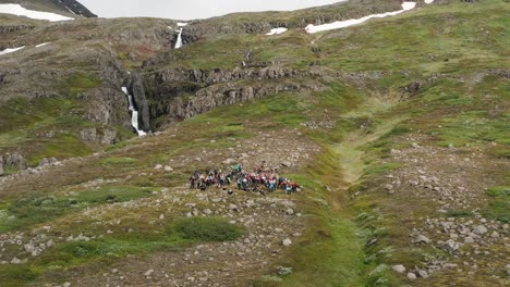 group of people gathered on slope of mount hólmatindur during hiking