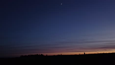 lone man silhouette walking after dusk.