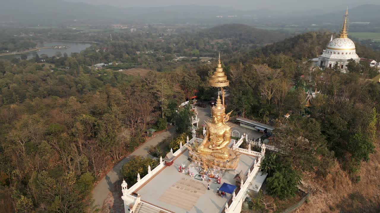 Aerial View of a Golden Buddha Statue on a Hilltop Temple