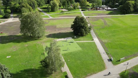 Parkside-activity-during-a-beautiful-summer-day-surrounded-by-lush-greenery,-grass-and-trees