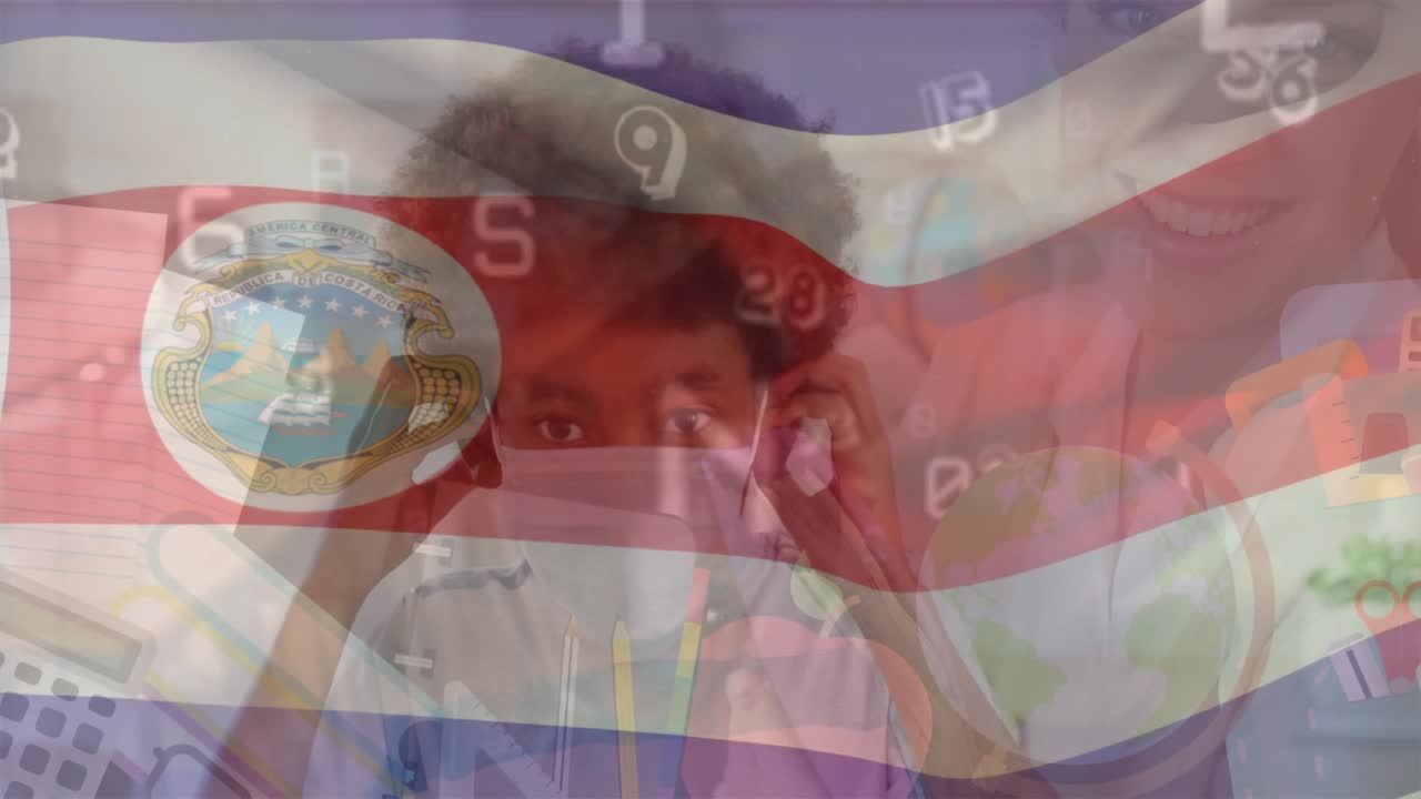 Niño afroamericano llevando una mascarilla en la escuela con una maestra caucásica
