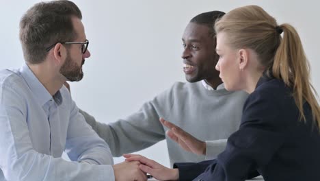 business people reassuring upset businessman