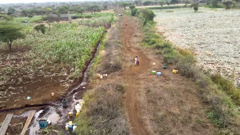 People-fetching-water-in-rural-village-of-Africa