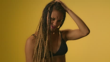 African-american-woman-in-doubt-thinking-and-holding-head-and-hair-with-hand