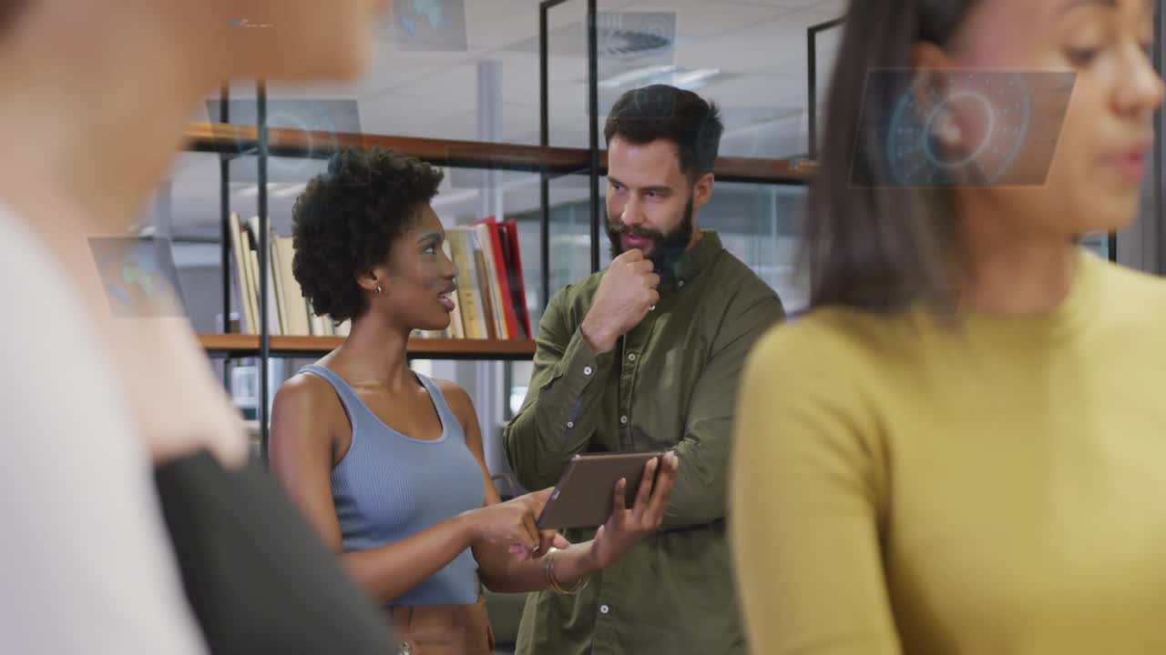 Woman with tablet tapping, initiating holograms appearing over center while reviewing business data