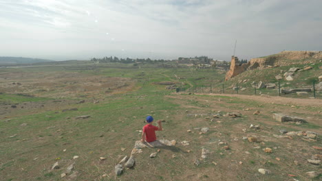 Child-looking-at-ruins-of-ancient-city-Hierapolis-in-Pamukkale-Turkey