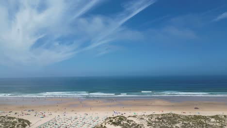 flying shot of waves during sunrise at costa da caparica beach in portugal