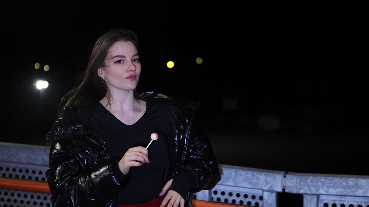 Happy and carefree girl alone at night