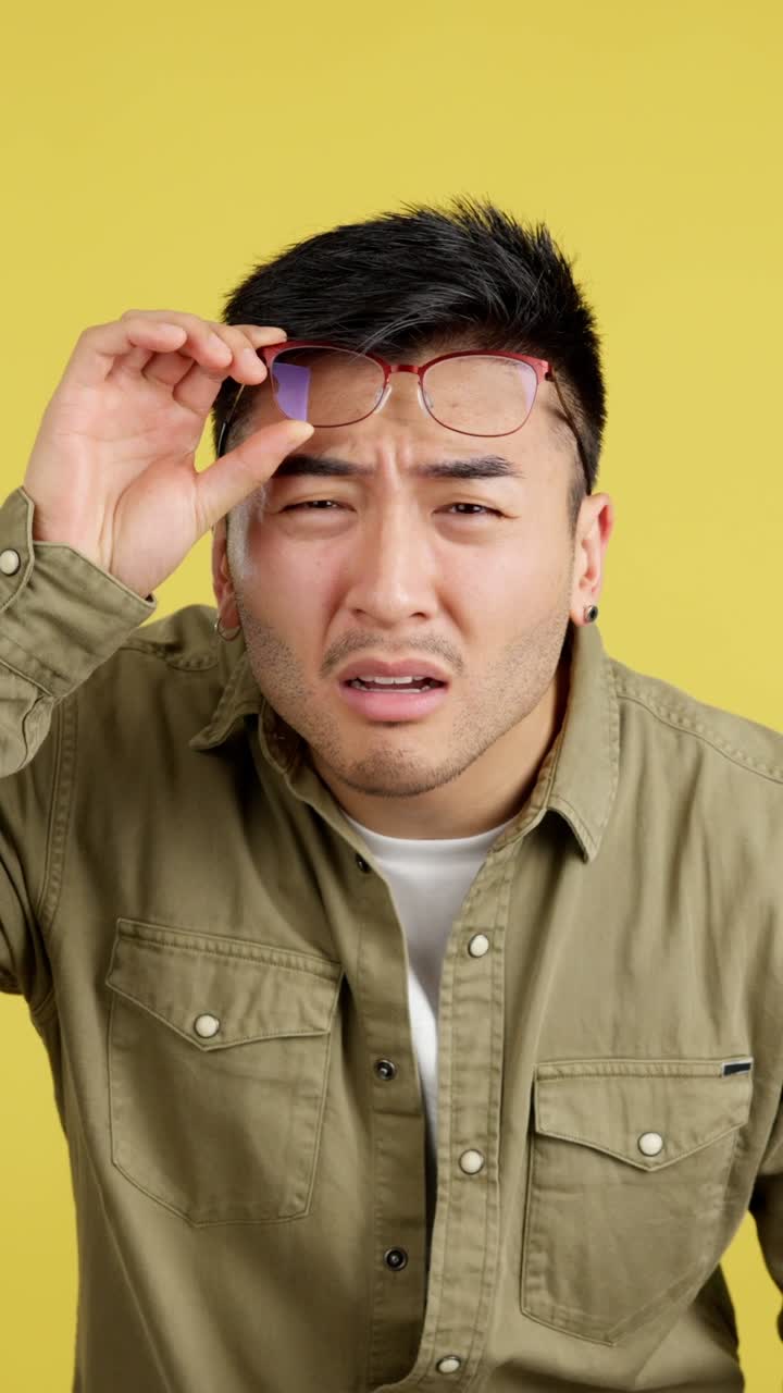 Man with glasses looking frustrated