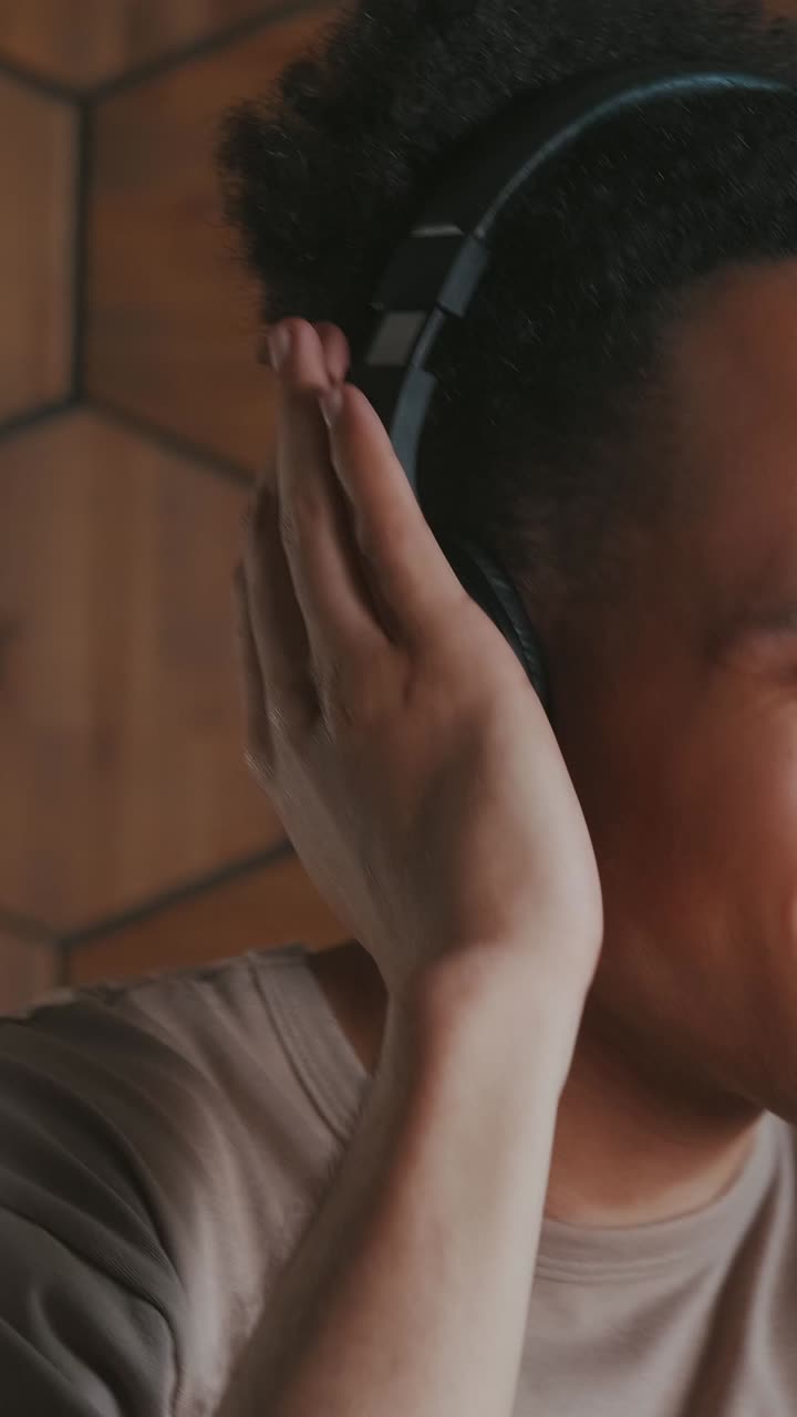 Singing passionately while immersed in music at a cozy studio