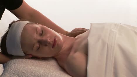 a woman receiving a facial massage