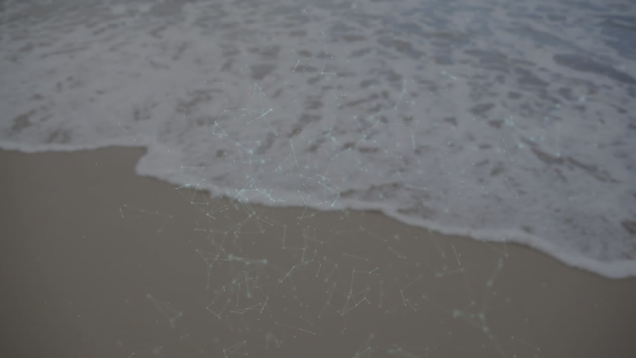 Glowing animation of network connections over ocean waves at sandy beach