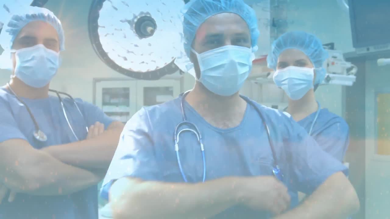 Composición digital de destellos de luz frente a un equipo de cirujanos con mascarillas en el hospital