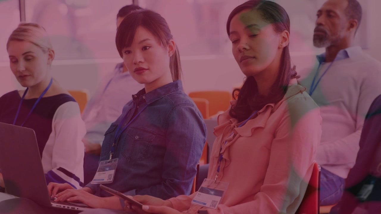 Three women attendees using devices in business conference, pink overlay appearing, hiding faces