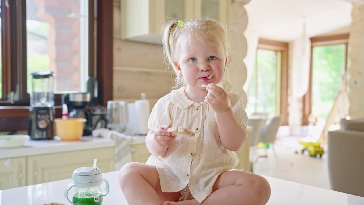 Toddler Eating Breakfast in Kitchen