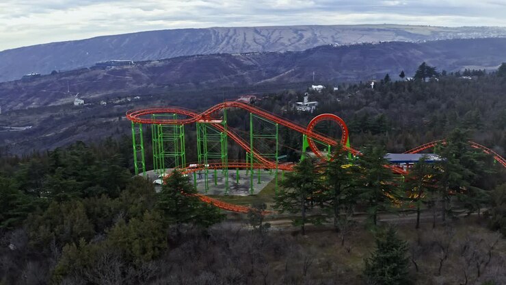 Roller Coaster At Mtatsminda Park On Mountain In Tbilisi, Georgia. ascending drone shot