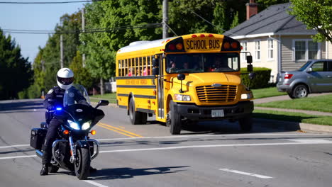 police officer escorts school bus