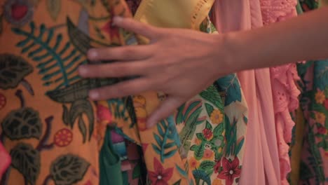 woman hand moves on an embroidered shirt with traditional ornament