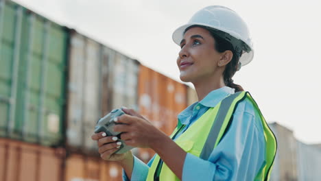 female engineer operating drone camera at port