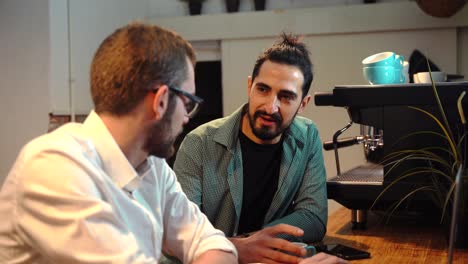 Baristas-discussing-work-issues-in-cafe