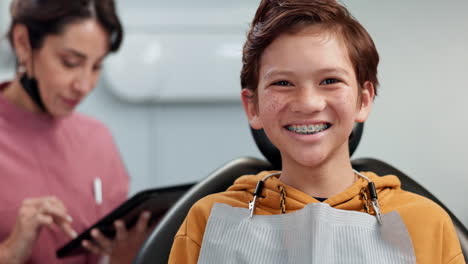 smiling boy with braces at the dentist