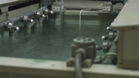 Macro-dolly-shot-of-spray-nozzles-in-an-industrial-chemical-bath