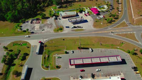 Aerial-of-semi-truck-exiting-truck-stop-at-Jasper,-Florida