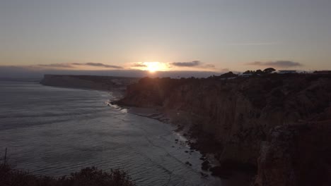 Los-últimos-Rayos-De-La-Silueta-Del-Atardecer-Acantilados-Costeros-De-Lagos,-Portugal,-Amplio