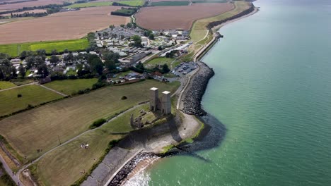 high altitude drone video showing the reculver towers next to the sea in the summer sunshine