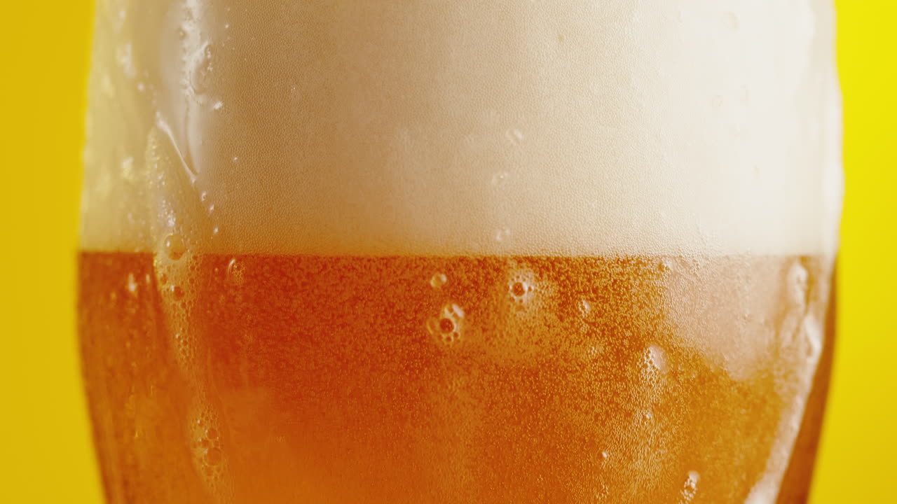 Closeup of a Glass of Beer with Frothy Foam