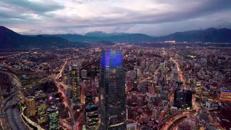 dolly out aerial view of illuminated buildings at night in santiago, chile