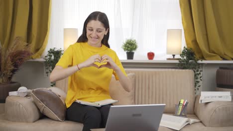 Female-student-Chatting-with-Beloved-on-Laptop.