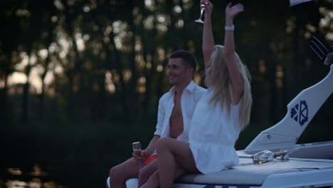 happy lovers boating on river in evening. love couple enjoy walk on water