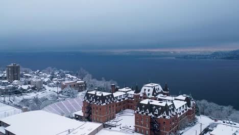 Snowy-Stadium-Bowl-Beside-Public-High-School-With-Commencement-Bay-In-Background-In-Winter-At-Stadium-District,-Tacoma,-Washington,-USA