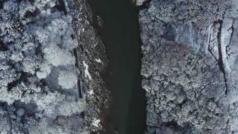 aerial winter scene in arashiyama in kyoto, flying along katsura river