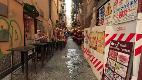 a bustling alley with pizza and people