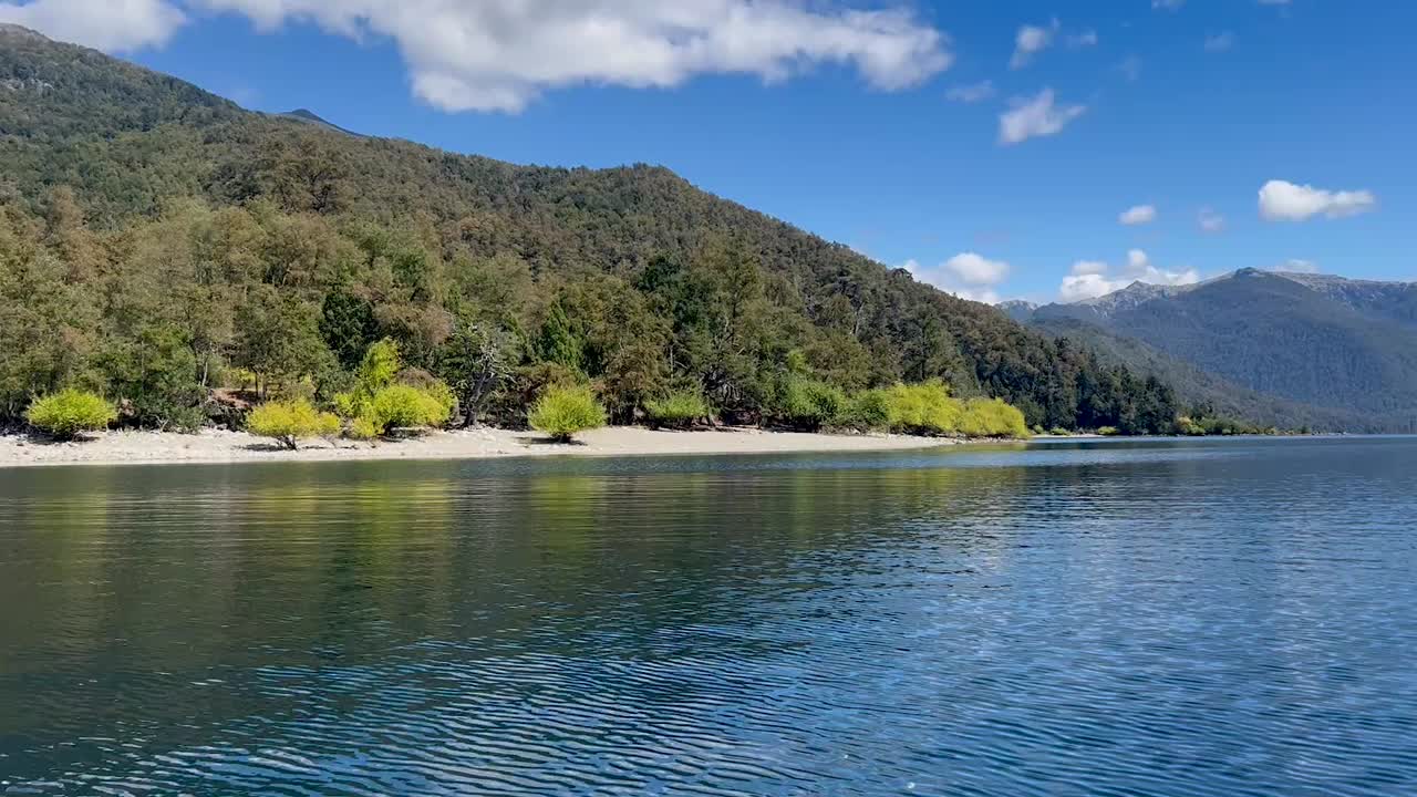 Lago Lacar Quila Quina in Argentina, showcasing calm waters, lush greenery, and mountains