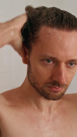 man washing hair in shower