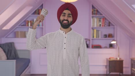 Happy-Sikh-Indian-man-using-money-as-fan