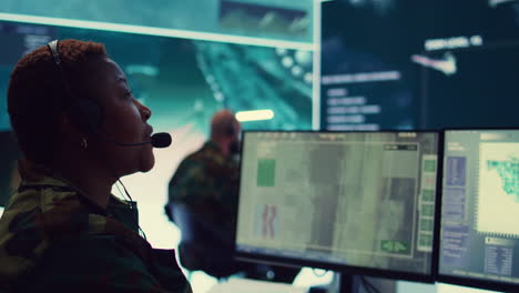 woman military personnel tracking enemy vessels on the coast line territory