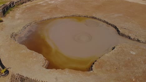 l'eau michel mud volcano is a wet type volcano with mud rising in the form of bubbles and then flowing down the sides of the cone