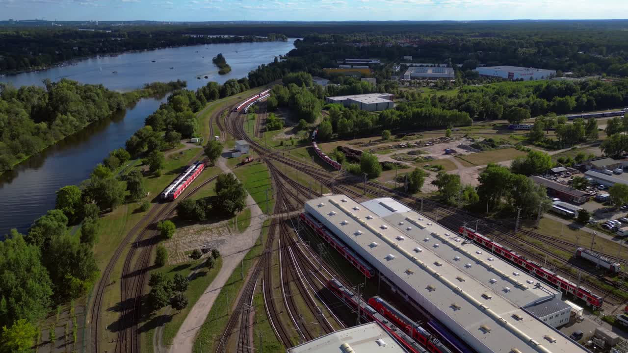 Hennigsdorf railway factory train depot overlooking the river in Brandenburg, Germany. Unbelievable aerial view flight fly reverse drone