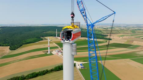 Construction-Of-Head-Of-Wind-Turbine-In-Scenic-Fields---aerial,-close-up