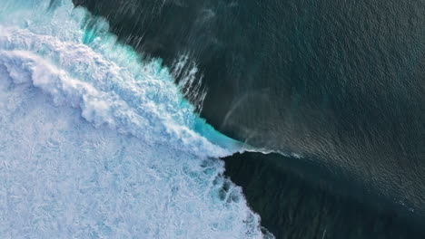 aerial view of powerful ocean waves crashing on the shore