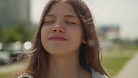 Pensive-teen-female-with-long-hair-fantasizes-closing-eyes