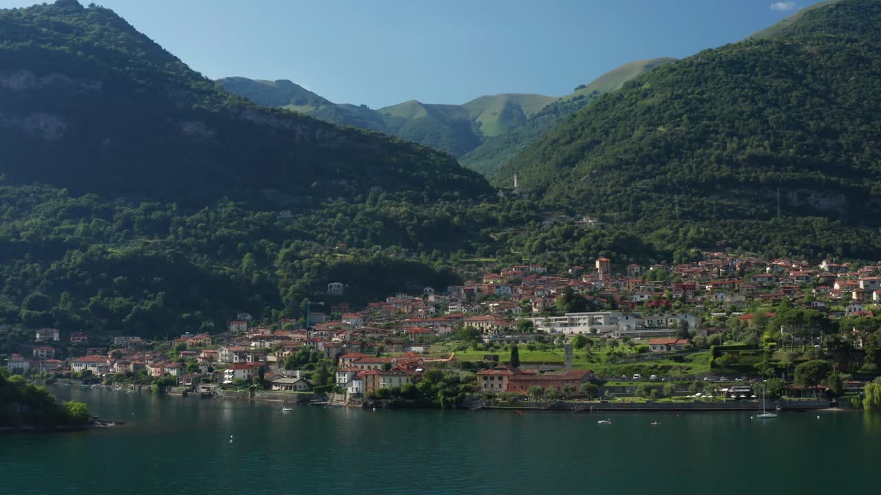 ossuccio en el lago como, vegetación exuberante y montañas, día soleado, vista aérea