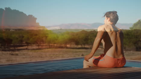 man sitting on a pool deck